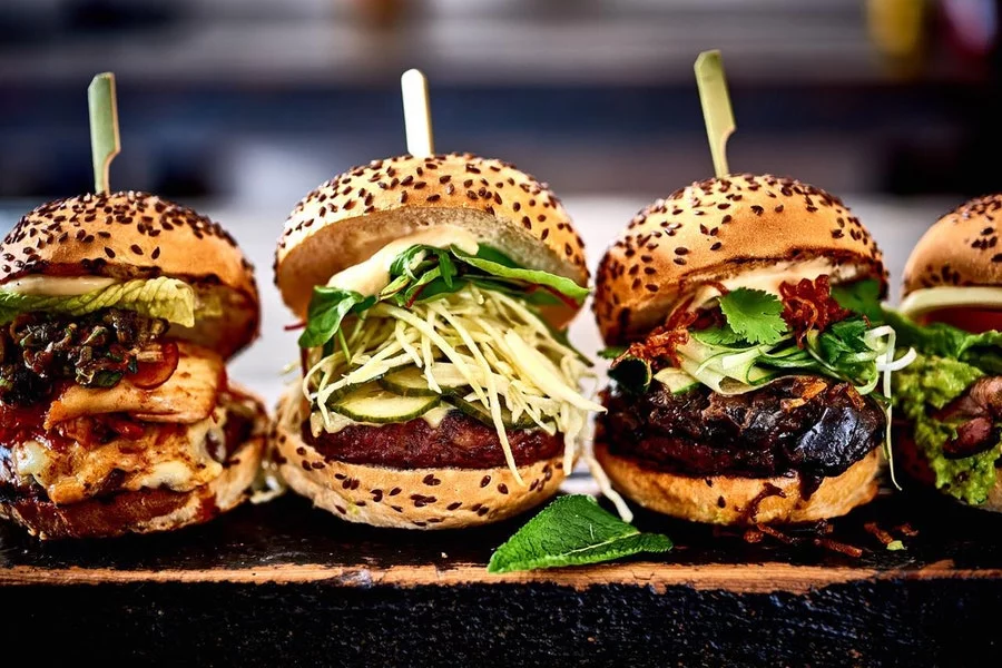 4 different Blas burgers displaying a variety of different toppings