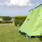 Side view of green tent pitched at Polmanter