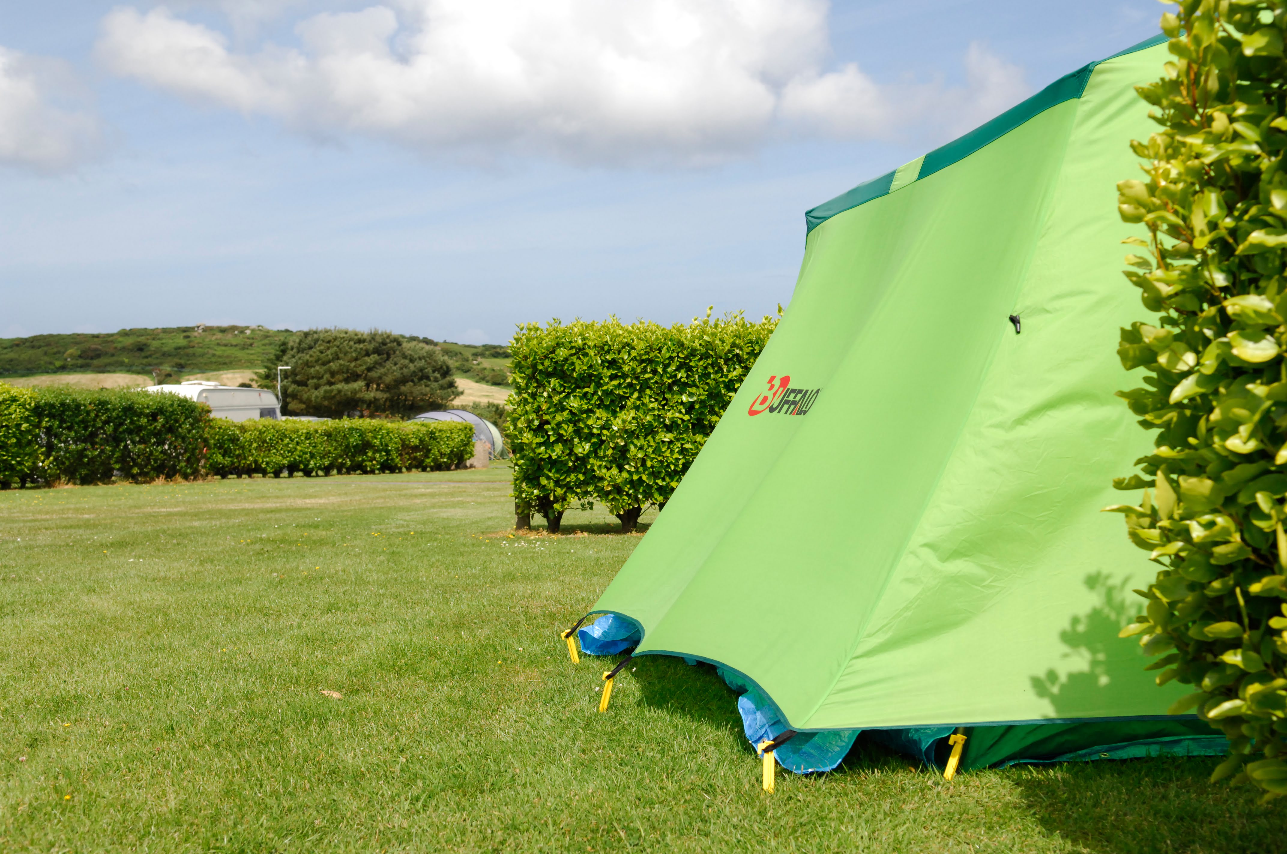 Side view of green tent pitched at Polmanter