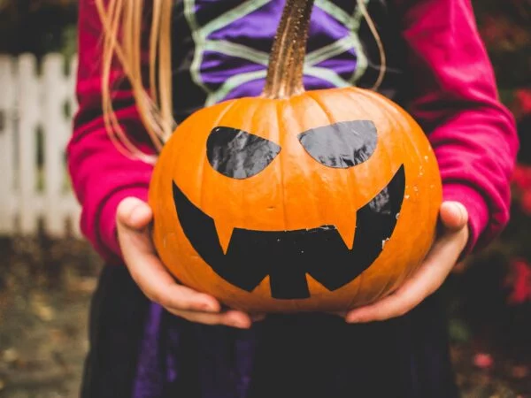 Child holding a pumpkin for October half term