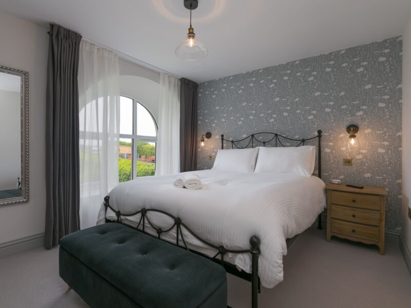 King size bed in Bedroom Two of Polmanter Touring Park's self-catering holiday cottage St Ives