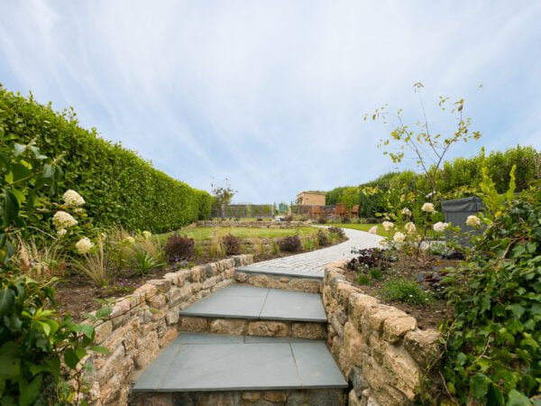 Steps up to the landscaped garden at Polmanter Touring Park's self-catering holiday cottage St Ives