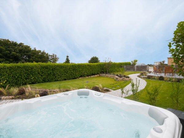 Hot tub in the landscaped garden of Polmanter Touring Park's self-catering holiday cottage St Ives